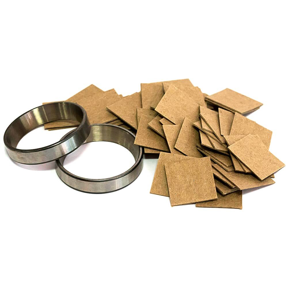 ARMOR SHIELD Chipboards piled next to metal rings